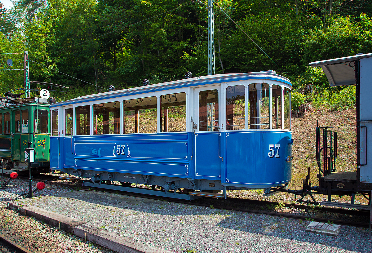 Der zweiachsige Straßenbahn-Beiwagen C 57, ex VMCV C 57, ex BVB C 57 am 19.05.2018 auf dem Museums-Areal der Museumsbahn Blonay-Chamby. 

Der Beiwagen wurde 1930 von SIG (Schweizerische Industrie-Gesellschaft) in Neuhausen am Rheinfall für die Straßenbahn VMCV (Transports publics Vevey–Montreux–Chillon–Villeneuve) gebaut. Die Straßenbahn wurde bis 1958 schrittweise komplett eingestellt und durch den Trolleybus Vevey–Villeneuve ersetzt. So ging der Wagen 1958 an die BVG (Bex-Villars-Bretaye-Bahn, französisch Chemin de fer Bex–Villars–Bretaye, heute TPC), 1970 wurde der Wagen an die Blonay-Chamby verkauft, wo er aber nur ausgestellt war. Im Januar 1999 ging er als Leihgabe an die BVB zurück, wo er vom Förderverein repariert und restauriert wurde. Im Juni 2011 ging der Wagen wieder an die Blonay-Chamby zurück. Seit 2013 ist er nun wieder in den ursprünglichen VMCV C2 57 um bezeichnet. Nur fährt er nicht mehr an der Waadtländer Riviera, sondern etwas oberhalb von ihr.

TECHNISCHE DATEN:
Spurweite: 1.000 mm (Meterspur)
Achsanzahl: 2
Länge über Kupplung: 8.830 mm
Länge Wagenkasten: 8.130 mm
Breite: 2.000 mm
Achsabstand: 2.900 mm
Eigengewicht: 5.400 kg
Sitzplätze: 18
Stehplätze: 31

Geschichte der VMCV:
Die erste elektrische Straßenbahn der Schweiz wurde im April 1888 zwischen Vevey, Montreux und Chillon (VMC) in Betrieb genommen, sie war so auch die erste elektrische Bahn der Schweiz überhaupt.

Diese Linie war eine Attraktion für die vielen ausländischen Gäste, die in den Luxushotels übernachten, die Ende des 19. Jahrhunderts an diesem privilegierten Teil der Waadtländer Riviera eingerichtet wurden. Die 1881 in Paris stattfindende Great Electricity Exhibition überzeugte die Projektträger von Vevey, diese revolutionäre Traktionsmethode anstelle der ursprünglich geplanten Druckluft anzuwenden. 

Die Fahrleitung war zweipolig und bestand aus einem aufgehängten, unten geschlitzten Kupferrohr in dem ein Kontaktschlitten über eine Leine mit Stromkabel vom Tramwagen mitgezogen wurde (System SIEMENS). Die Schienen wurden nicht als Rückleiter benutzt. Die ersten Motorwagen hatten sogar ein begehbares Dach mit Bänken, wo auch in den ersten Betriebsjahren ein Mitarbeiter saß, das komplexe und heikle System der Stromzuführung überwachte und führte.

Die Konzession für die Verlängerung Chillon – Byron – Villeneuve ging dann an die CBV welche den Betrieb 1903 eröffnete. Die Betriebsführung hatte die VMC. Im Jahr 1913 fusionierten die beiden Gesellschaften zur VMCV und erneuerten die Straßenbahn komplett. Neue Fahrleitung im nun gebräuchlichen System, vollständig neues Rollmaterial und größtenteils erneuertes Gleis.

Das Tram wurde immer sehr gut frequentiert, doch auch hier brachte der Straßenverkehr die Bahn in Bedrängnis. Als es dann darum ging das ausschließlich zweiachsige Rollmaterial meist von 1913 zu ersetzen, entschloss sich das Unternehmen auf Trolleybus umzustellen.
