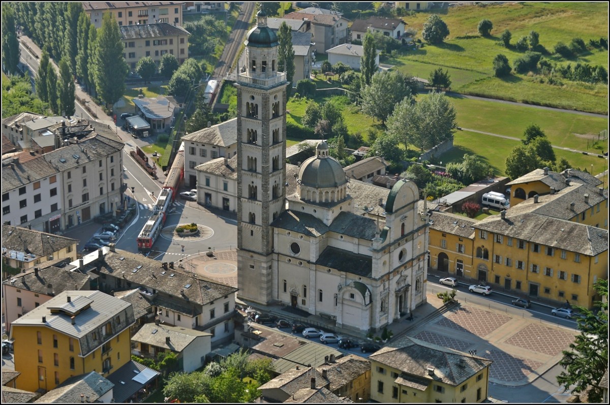 Die beiden ABe 4/4<sup>III</sup> 55 Diavolezza und 56 Corviglia auf der Piazza Basilica in Tirano neben der Wallfahrtskirche Madonna di Tirano. Juli 2013.