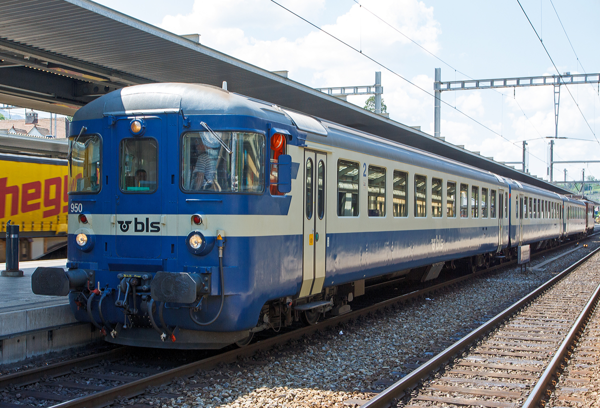 Hier nochmal der...
BLS 1. und 2. Klasse Personenwagen AB 50 63 39-33 890-3 ein Einheitswagen I (EW I) eingereiht am 28.05.2012 in einem BLS EW I – Pendelzug im Bahnhof Spiez. Den AB Wagen kann man auch gut an den unterschiedlichen Fensteraufteilungen erkennen.

Der EW I Wagen ist Baujahr 1961. Ab 1990 baute die BLS die EW I Wagen auf außenbündige Türen für NPZ um.

TECHNISCHE DATEN:
Spurweite: 1.435 mm (Normalspur)
Wagenlänge über Puffer:  24.700 mm
Drehzapfenabstand: 17.600 mm
Eigengewicht: 32 t
Sitzplätze: 24 in der 1. Klasse und 38 in der 2. Klasse
Bremse:  O-R

Die Einheitswagen I sind die Nachfolger der Leichtstahlwagen und wurden zwischen 1956 und 1967 gebaut. Sie hatten ein Gewicht von 28 bis 32 Tonnen, eine Länge von 23,7 m und eine zulässige Höchstgeschwindigkeit von 140 km/h.Damit die Einstiege über dem Drehgestell angeordnet werden konnten, wurden die Drehgestellrahmen in der Mitte gekröpft ausgeführt. Die Primärfederung (zwischen Rad und Drehgestellrahmen) erfolgt durch Schraubenfedern, für die Sekundärfederung (zwischen Drehgestellrahmen und Wagenkasten) kamen zwei Varianten zur Ausführung SWS mit Schraubenfedern oder SIG mit Torsionsstäben.