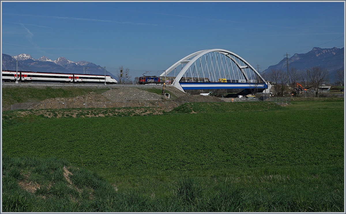 Zuviel des Guten: Die neuen Rohnebrücke bei Massogex an der Strecke Bex - St-Maurice macht weitaus bessers Bild, wenn ein Zug ihre Umgebung ziert, doch wenn geleich zwei Züge auf einem kommen, hält sich die Freude des Fotografen in Grenzen...
ETR 610 nach Genève und eine SBB Cargo Re 420 mit einem Güterzug Richtung St-Maurice.
27. März 2017 