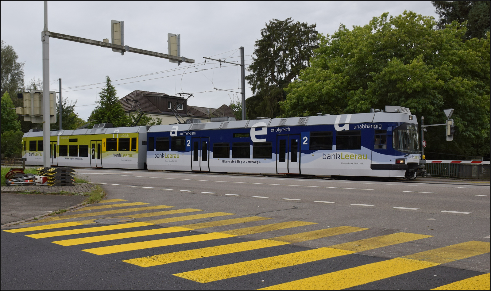 ABe 4/8 33 der WSB mit Bank-Leerau-Werbung f�hrt in Richtung Aarau Bahnhof. Diese Wagen wurden Anfang der 2010er Jahre mit den k�rzeren Wagen der BDWM neu kombiniert. Nur dieser Zug besteht aus zwei langen Wagen ex 33 und 34 der WSB, heute AVA. August 2024.