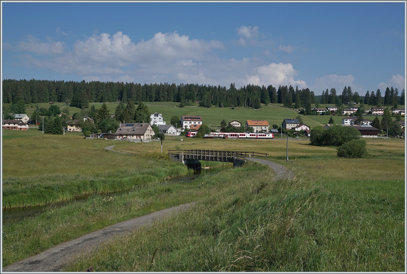 Kurz vor der Umstellung auf das neue Betriebskonzept mit den direkten Zügen Le Brassus - Aigle: Der TRAVYS RBDe 560 385-7 (RBDe 560 DO TR 94 85 7560 385-7 CH-TVYS)  Lac de Joux  ist als Regionalzug von Le Brassus nach Vallorbe unterwegs und konnte hier an der Orbe (links unten im Bild) zwischen Le Brassus und Sentier Orient fotografiert werden. 

16. Juni 2022