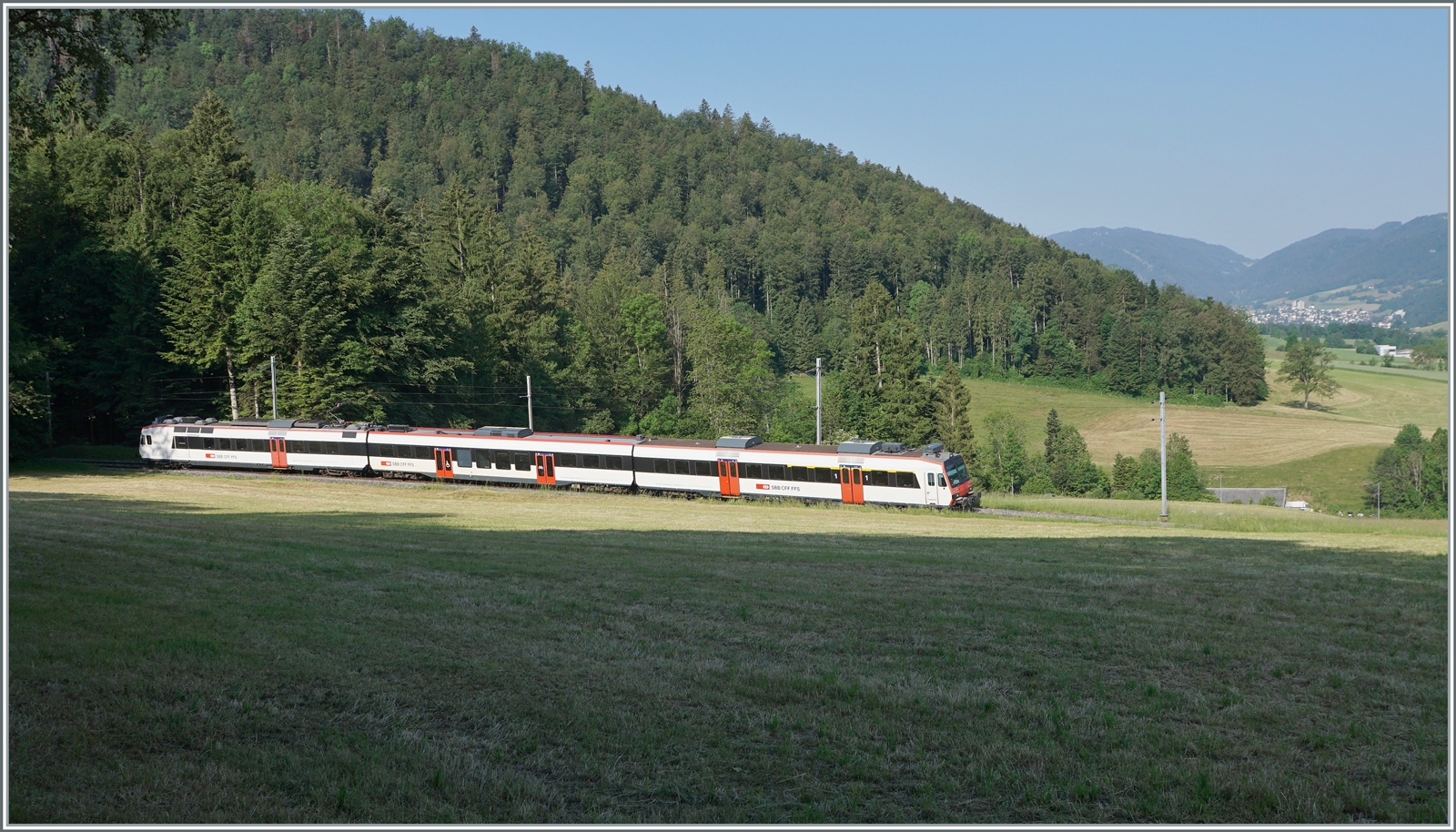 Obwohl zu Fuss abgemessen, war zwischen dem Wald und dem Einschnitt doch nur sehr kanpp Platz, um dem Regionalzug von Moutier nach Solothurn oberhalb von Crémines fotografieren zu können. Im Hintergrund ist der Zielort des Zuges, Moutier zu erkennen. 

5. Juni 2023