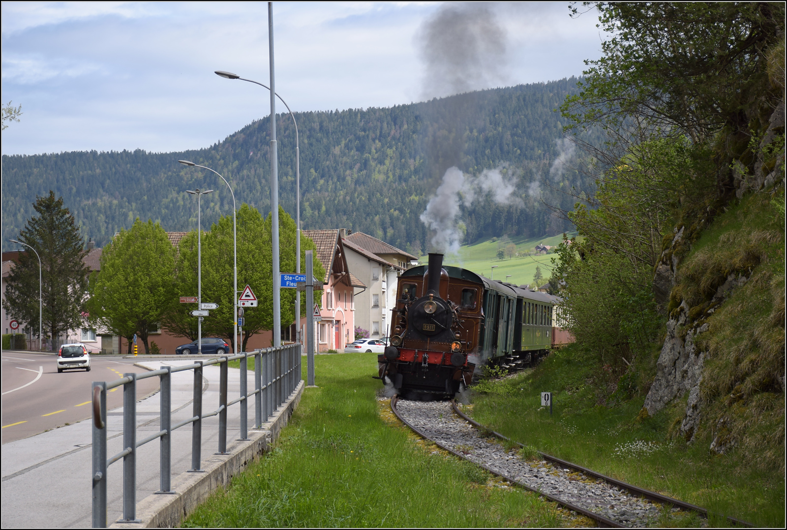 Train au fil de l'Areuse.

E 3/3 5811 fährt um die scharfe Kurve in den engen Canyon nach St-Sulpice. Fleurier, Mai 2024.